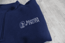 logo of the banner of truth quarter zip sweatshirt